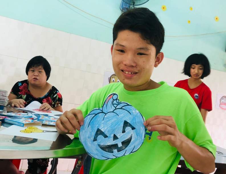 Child showing off a blue pumpkin